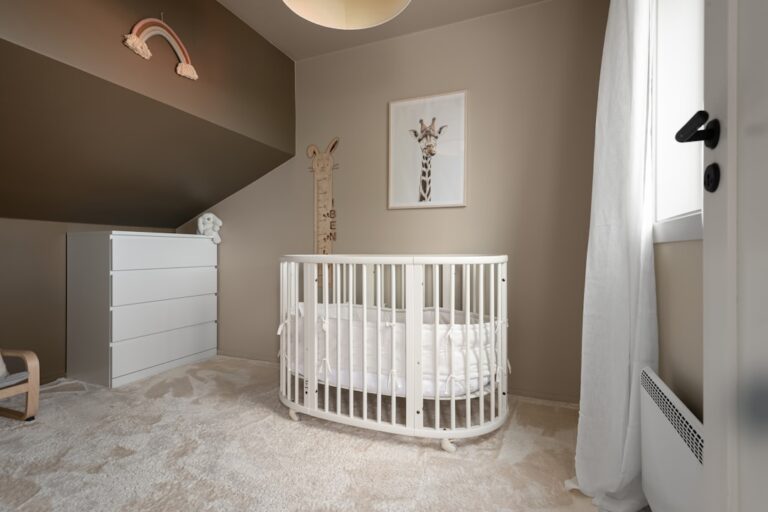 A baby's room with a crib and a rocking chair